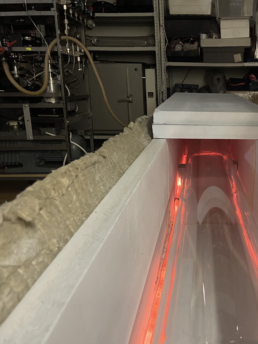 A tube glowing in the kiln during evacuation and cleaning